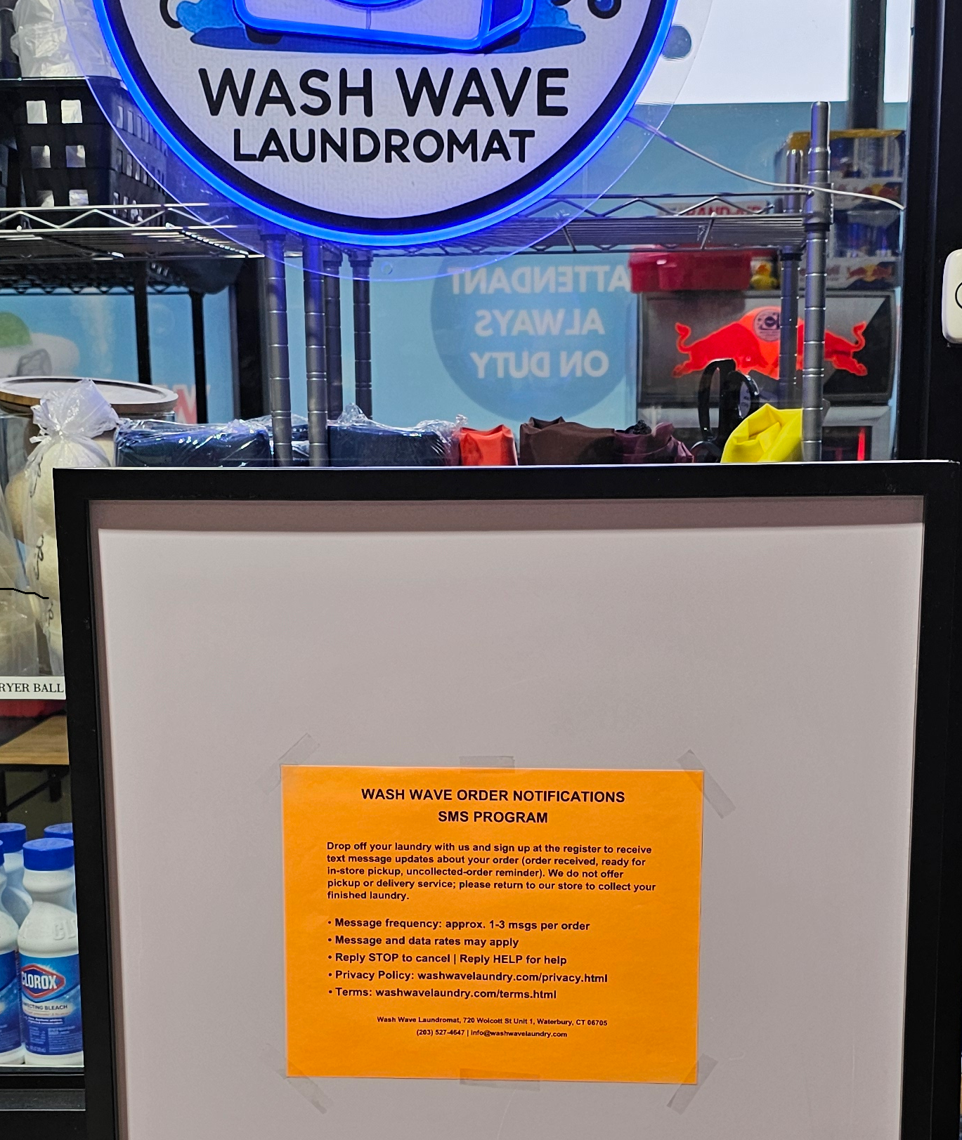 Wash Wave in-store SMS opt-in sign displayed at the register